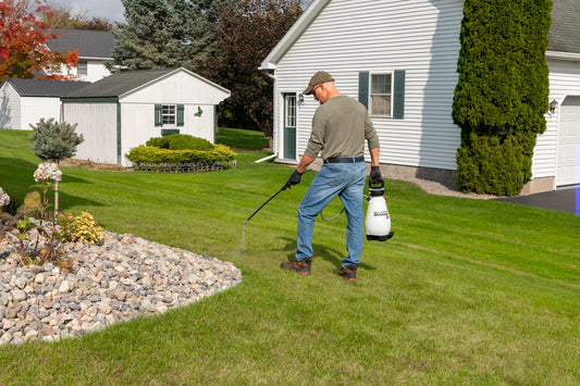 Smith Multi-Use 2 Gallon sprayer in use in a yard