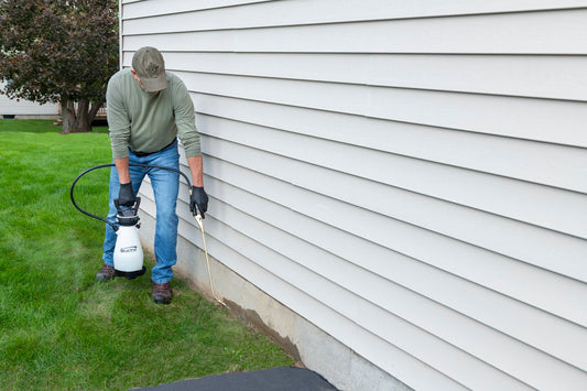 Smith Pump Zero pest sprayer treating a home foundation