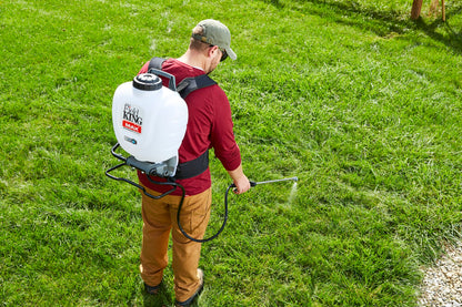 Field King Max Pro backpack sprayer treating a yard