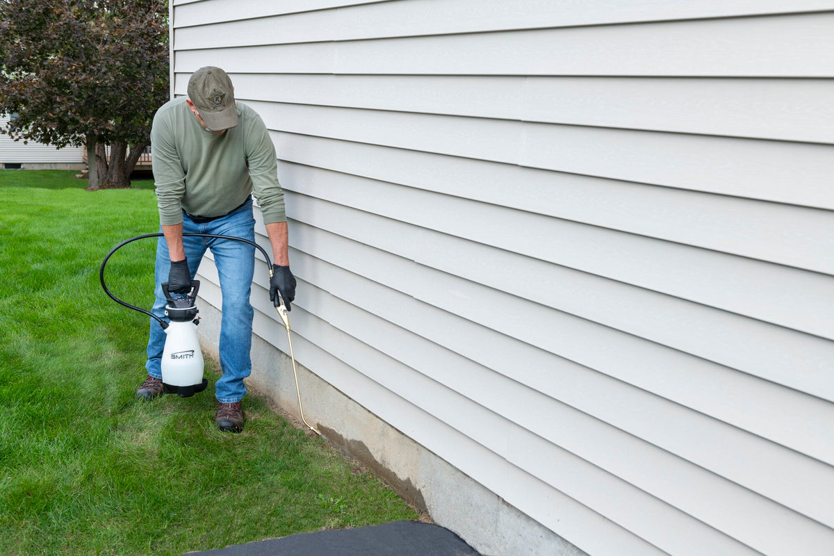 Smith Pump Zero pest sprayer treating a home foundation