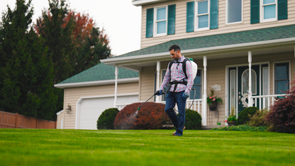 Scotts 4 Gallon battery backpack in use on a lawn