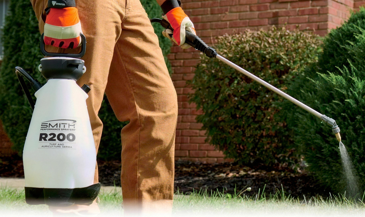 Professional applying treatment with an FGI sprayer